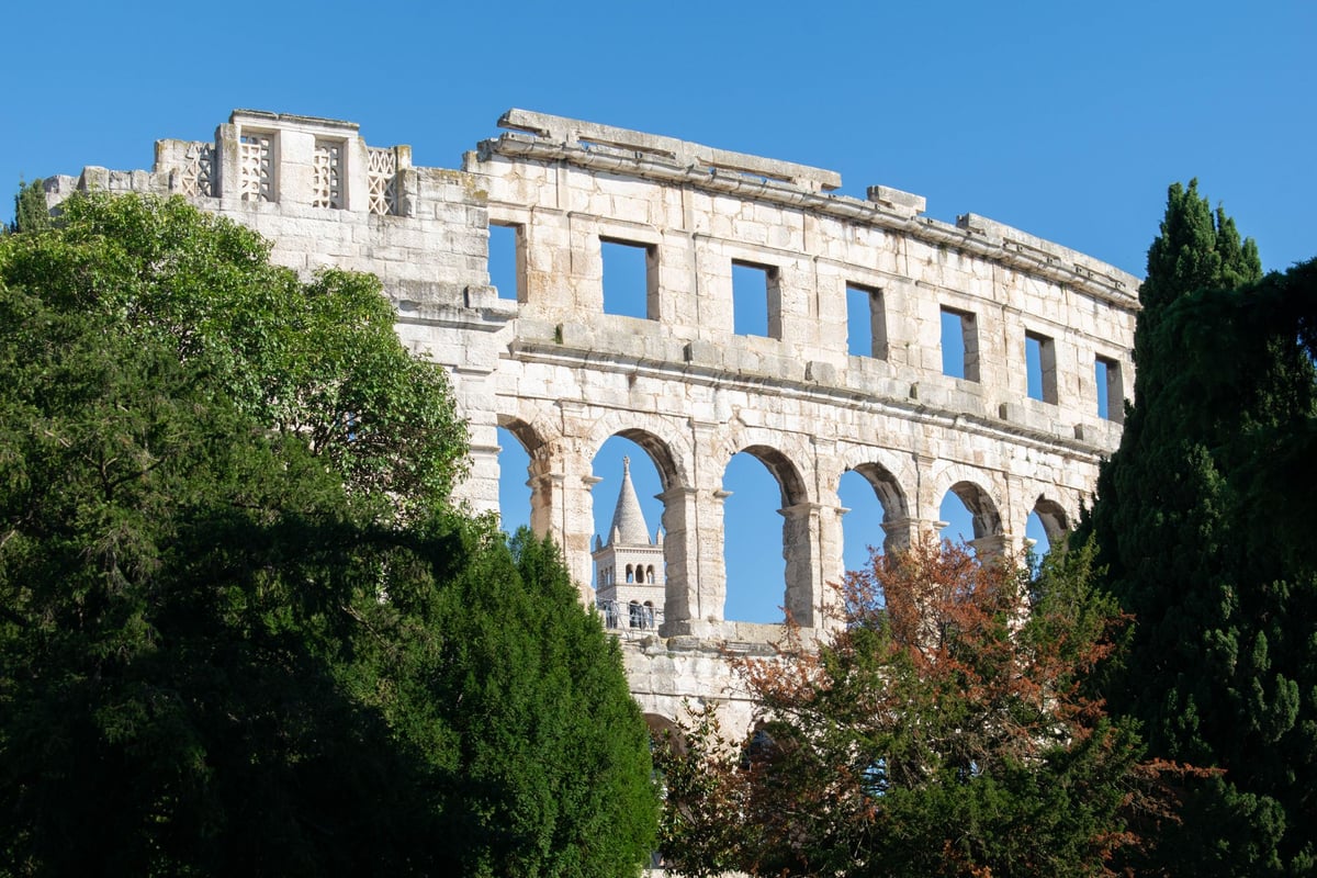 The Pula amphitheatre framed by greenery